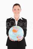 Pretty female in suit holding a globe