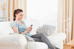 Attractive woman writing a text on her mobile phone
