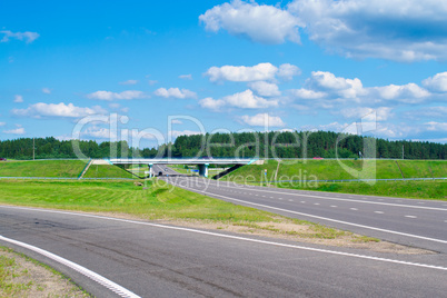 Road, gren grass and blue sky
