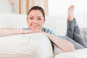 Good looking woman posing while lying on a sofa