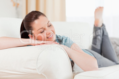 Charming woman posing while lying on a sofa