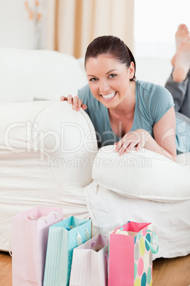 Charming woman posing while lying on a sofa