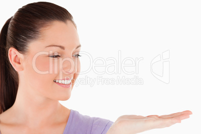 Portrait of a beautiful woman showing a copy space while standin