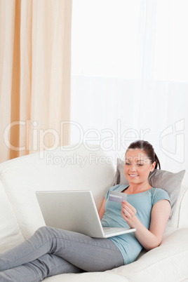 Good looking female making an online payment with her credit car