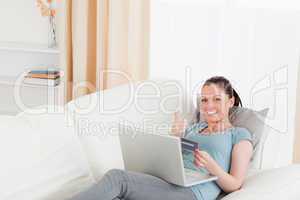 Attractive female making an online payment with her credit card