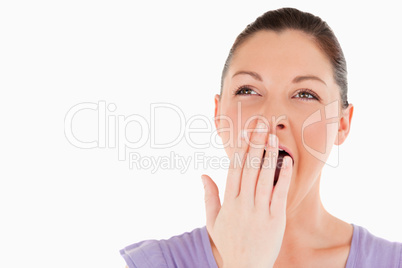Portrait of a beautiful woman yawning while standing