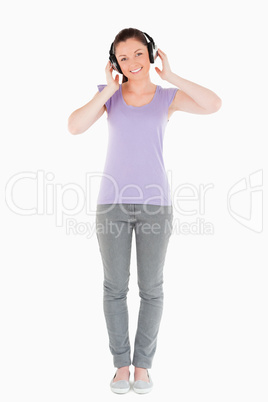 Attractive woman posing with headphones while standing