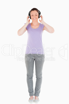 Beautiful woman posing with headphones while standing