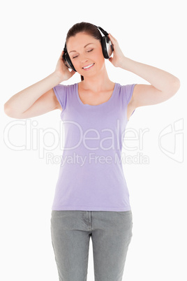 Gorgeous woman posing with headphones while standing