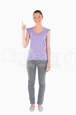 Good looking woman pointing at a copy space