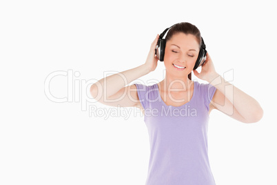 Pretty woman posing with headphones while standing