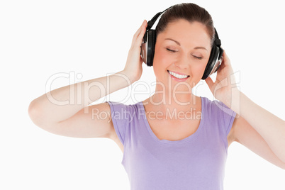 Lovely woman posing with headphones while standing