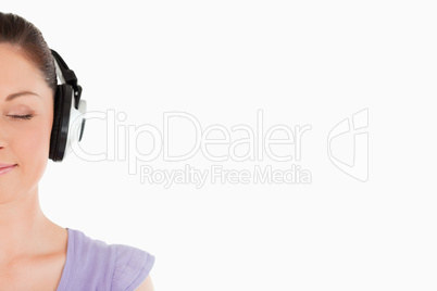 Portrait of an attractive woman posing with headphones while sta