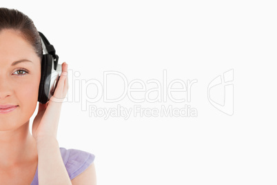 Portrait of a beautiful woman posing with headphones while stand