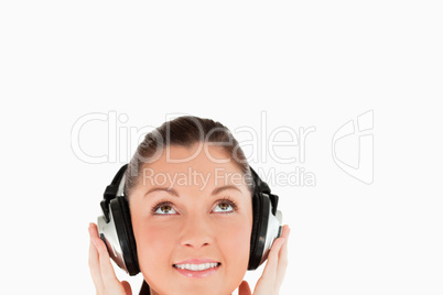 Portrait of a gorgeous woman posing with headphones while standi