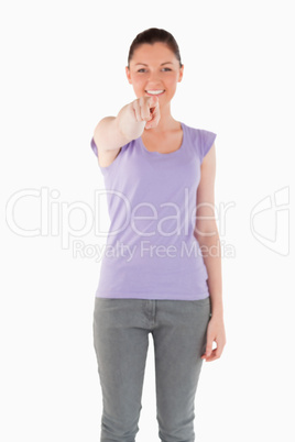 Good looking woman pointing at the camera while standing