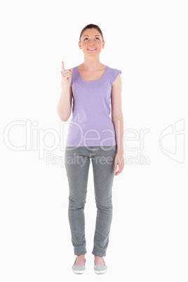 Attractive woman pointing at a copy space