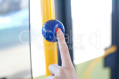 a finger pushes on a stop button
