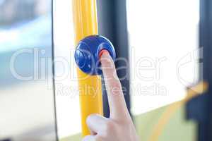 a finger pushes on a stop button