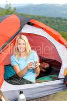Camping young woman drink mug sunset tent