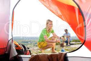 Camping young couple outside tent cook meal