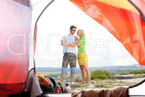 Camping young couple outside tent panoramic view