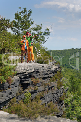 Hiking young couple point at panoramic view