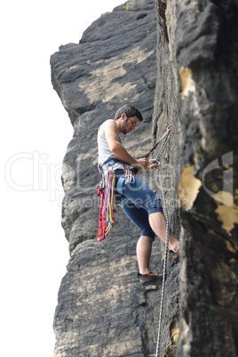 Rock climbing fit man on rope sunny