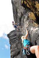 Rock climbing male instructor woman hang rope