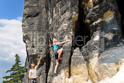 Rock climbing male instructor blond woman sunny