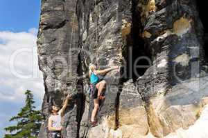 Rock climbing male instructor blond woman sunny