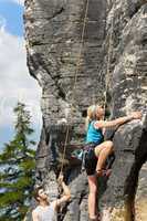 Rock climbing male instructor blond woman sunny