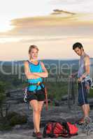 Rock climbing active people on top sunset
