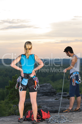 Rock climbing active people on top sunset