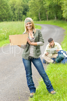 Hitch-hiking young couple backpack asphalt road