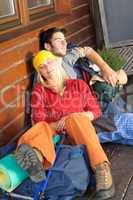Tramping young couple backpack sleep by cottage