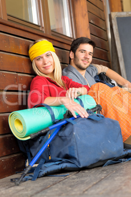 Tramping young couple backpack relax by cottage