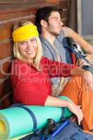 Tramping young couple backpack relax by cottage