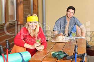 Tramping young couple relax by wooden table