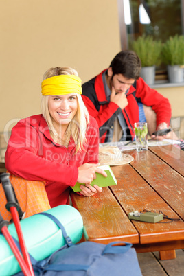 Tramping young couple relax by wooden table