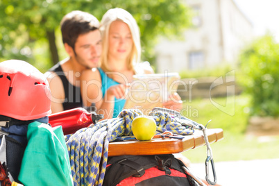 Young couple relax sunny terrace climbing gear