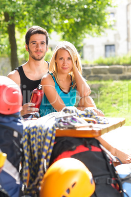 Young couple relax sunny terrace climbing gear