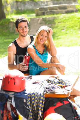 Young couple relax sunny terrace climbing gear