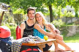 Young couple relax sunny terrace climbing gear