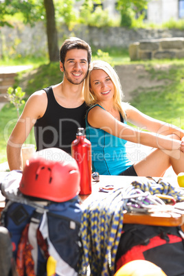 Young couple relax sunny terrace climbing gear