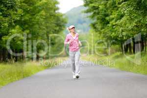 Jogging sportive young woman running park road