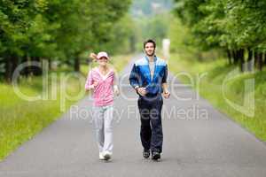 Jogging sportive young couple running park road