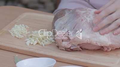 Piercing thick piece of pork with knife for marinating
