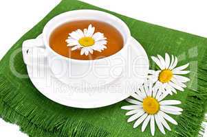 Herbal tea in a white cup with camomile