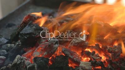 Close-up of glowing hot embers outdoors